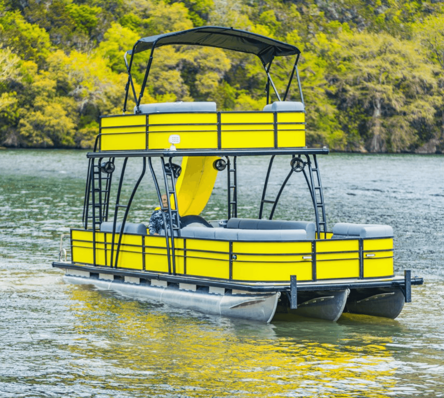 Yellow double-decker party boat with slide on Lake Travis